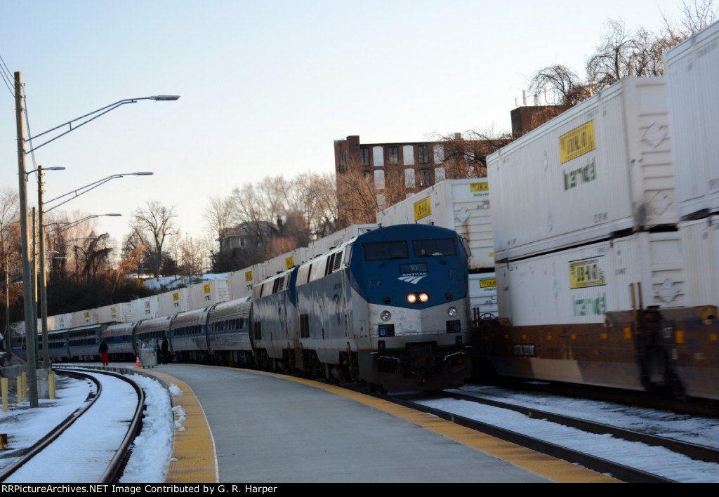 J.B. Hunt containers pass by Amtrak #20(21)
